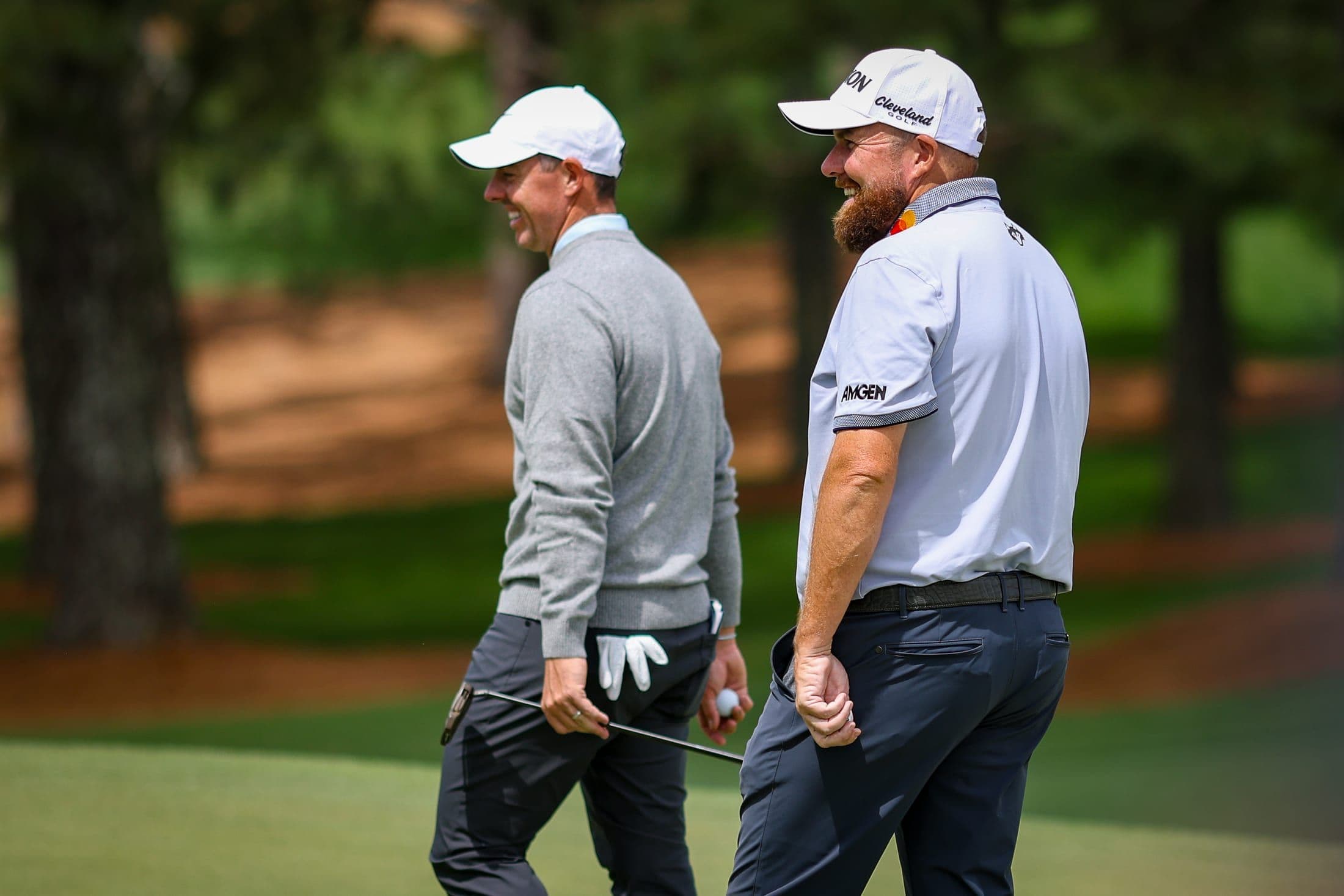 Rory McIlroy walking the course with a fellow golfer at the 2025 Masters